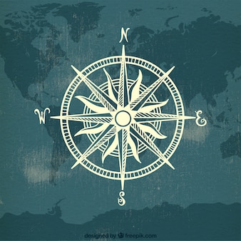 Kompas na tle mapy świata