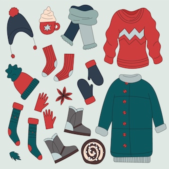 Ręcznie rysowana kolekcja zimowych ubrań i niezbędnych rzeczy