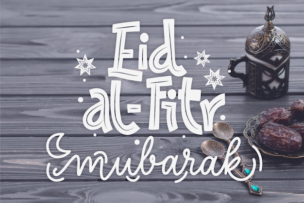 Bezpłatny wektor ręcznie rysowane napis eid al-fitr - eid mubarak