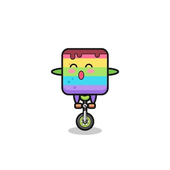 Urocza postać z tęczowego ciasta jedzie na rowerze cyrkowym