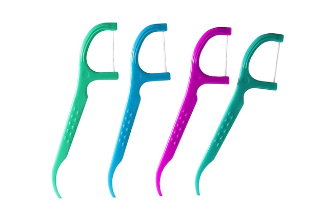 4 picks nici dentystycznej (plastikowe) na białym tle na białym tle. (zielony, niebieski, różowy) łatwa w użyciu nić dentystyczna z uchwytem.