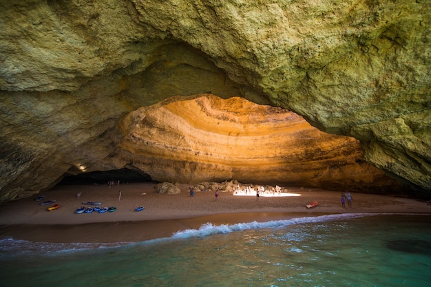 Benagil Cave Boat Tour w Algar de Benagil, jaskini wymienionej w 10 najlepszych jaskiniach na świecie. Wybrzeże Algarve w pobliżu Lagoa, Portugalia. Turyści odwiedzają popularny punkt orientacyjny