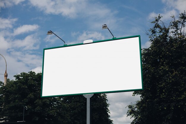 Biały billboard na zielonych liściach