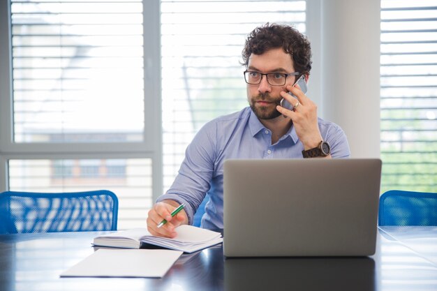 Biznesmen rozmawia telefonu w biurze