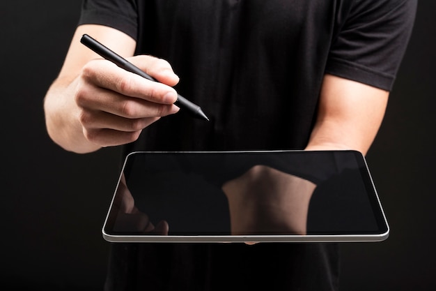 Biznesmen trzyma tablet i pisze niewidoczny ekran z rysikiem okładką mediów społecznościowych