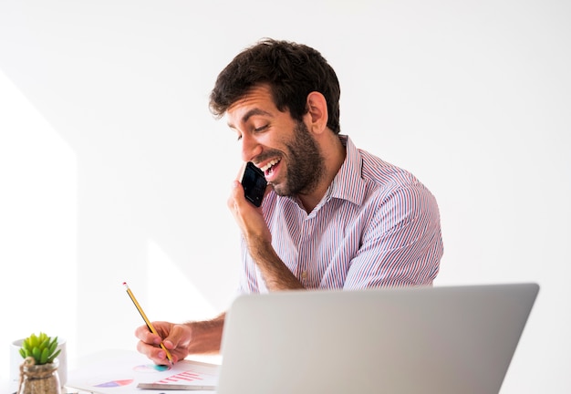 Bezpłatne zdjęcie biznesowy mężczyzna pracuje z telefonem komórkowym i laptopem