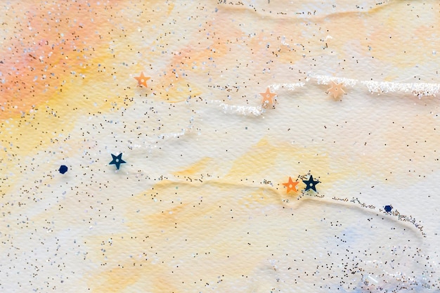 Błyszczące konfetti gwiazd na kolorowe abstrakcyjne pastelowe tło akwarela