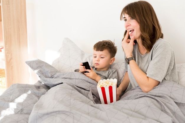 Bezpłatne zdjęcie buźka mama i syn jedzenie popcornu