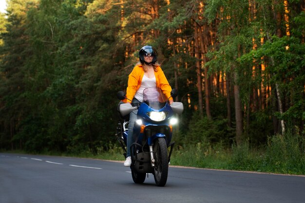 Całkowite ujęcie chłodnej starej kobiety na motocyklu.