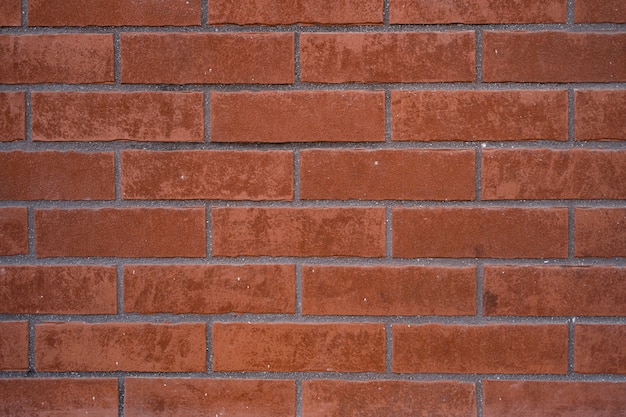 Ceglana ściana. Tekstura z czerwonej cegły z szarym wypełnieniem