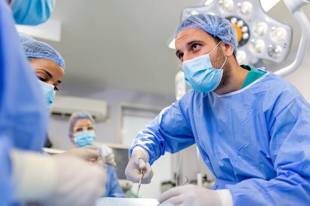 Chirurgiczny zespół medyczny działający w sali operacyjnej szpitala chirurga prowadzącego zawód operacyjny profesjonalizm zawód praca zespołowa ludzie medyczni lekarze koncepcja
