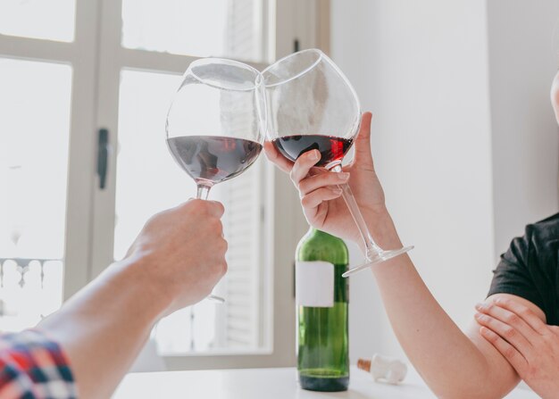Crop couple with glasses of wine