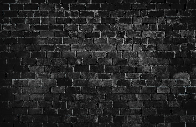 Czarne teksturowane tło ściany z cegły