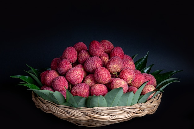 Bezpłatne zdjęcie czerwone owoce liczi umieszczone w koszu.