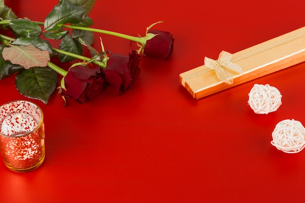 Bezpłatne zdjęcie czerwone róże z świeczką na stole