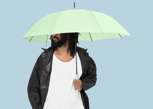 Człowiek posiadający zielony parasol