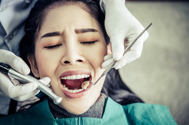 Dentysta bada zęby pacjenta.