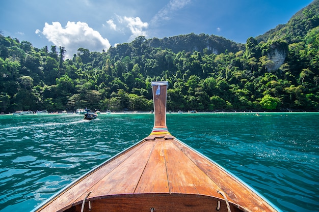 Długa łódź i błękitne wody przy majowią trzymać na dystans w Phi Phi wyspie, Krabi Tajlandia.