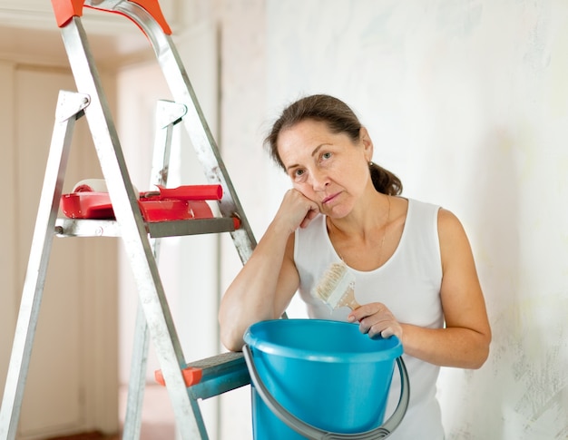 Bezpłatne zdjęcie dojrzała kobieta dokonuje napraw w domu