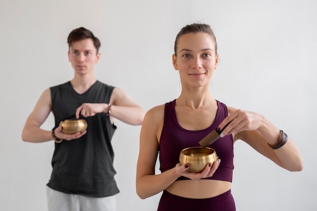 Duchowy młody mężczyzna i kobieta praktykujący jogę w pomieszczeniu