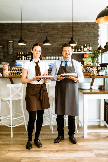 Bezpłatne zdjęcie dwóch barmanów z ciastem