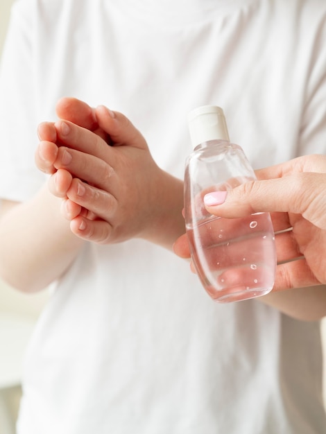 Dziecko za pomocą dezynfekcji rąk