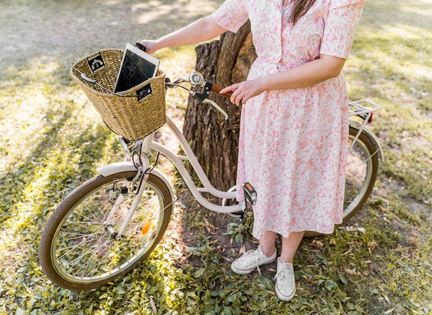 Bezpłatne zdjęcie elegancka młoda kobieta pozuje z rowerem