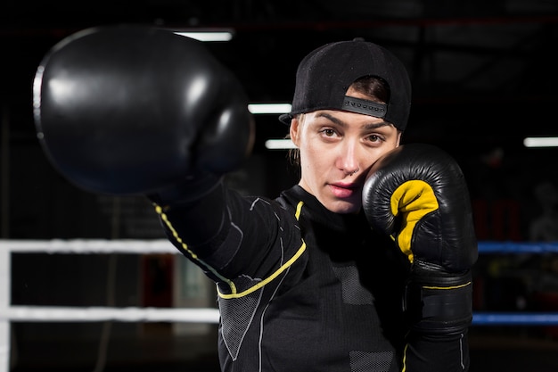 Bezpłatne zdjęcie frontowy widok pozuje w ochronnych rękawiczkach żeński bokser