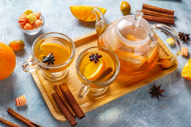 Bezpłatne zdjęcie gorąca zdrowa rozgrzewająca zimowa herbata z dodatkiem pomarańczy, miodu i cynamonu.
