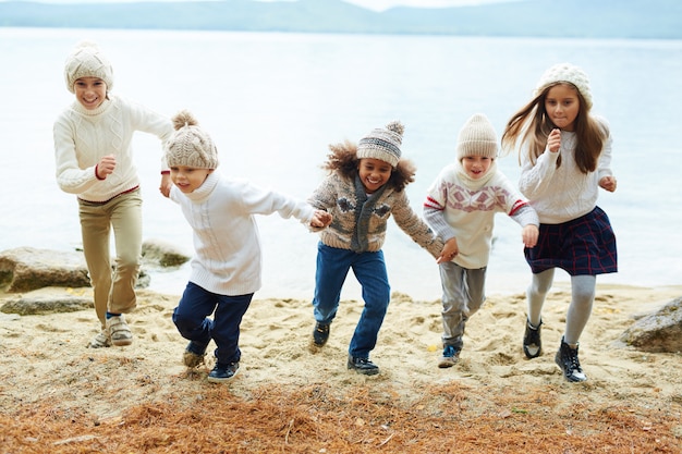 Happy Kids Running By Lake