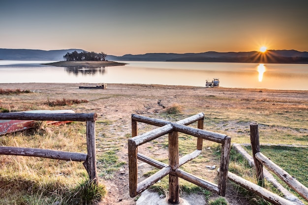 Bezpłatne zdjęcie hipnotyzujące ujęcie spokojnego jeziora o zachodzie słońca w bułgarii