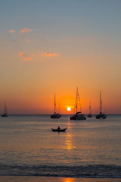Jacht na morzu podczas zachodu słońca