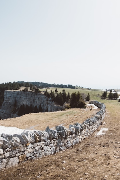 Kamienny Mur W Pobliżu Klifu Na Zielonym Polu Pod Pochmurnym Niebem