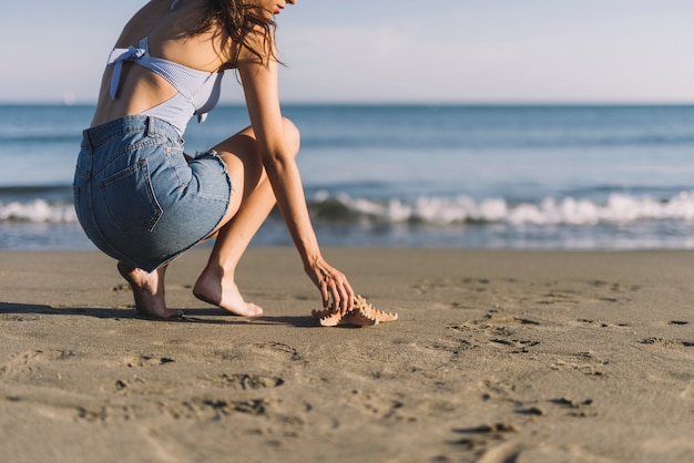 Kobieta Dotykania Rozgwiazda Na Plaży