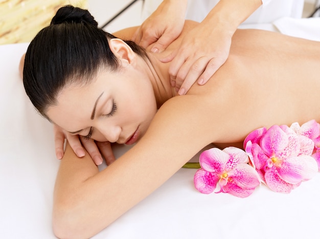 Kobieta na zdrowy masaż ciała w salonie spa. Koncepcja zabiegów kosmetycznych.