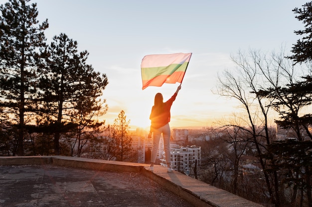Bezpłatne zdjęcie kobieta trzymająca flagę bułgarii na zewnątrz