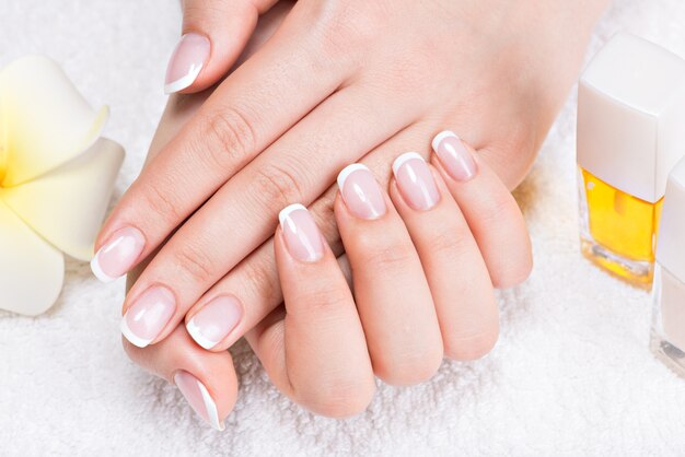Kobieta w salonie paznokci odbiera manicure przez kosmetyczkę. Koncepcja zabiegów kosmetycznych.
