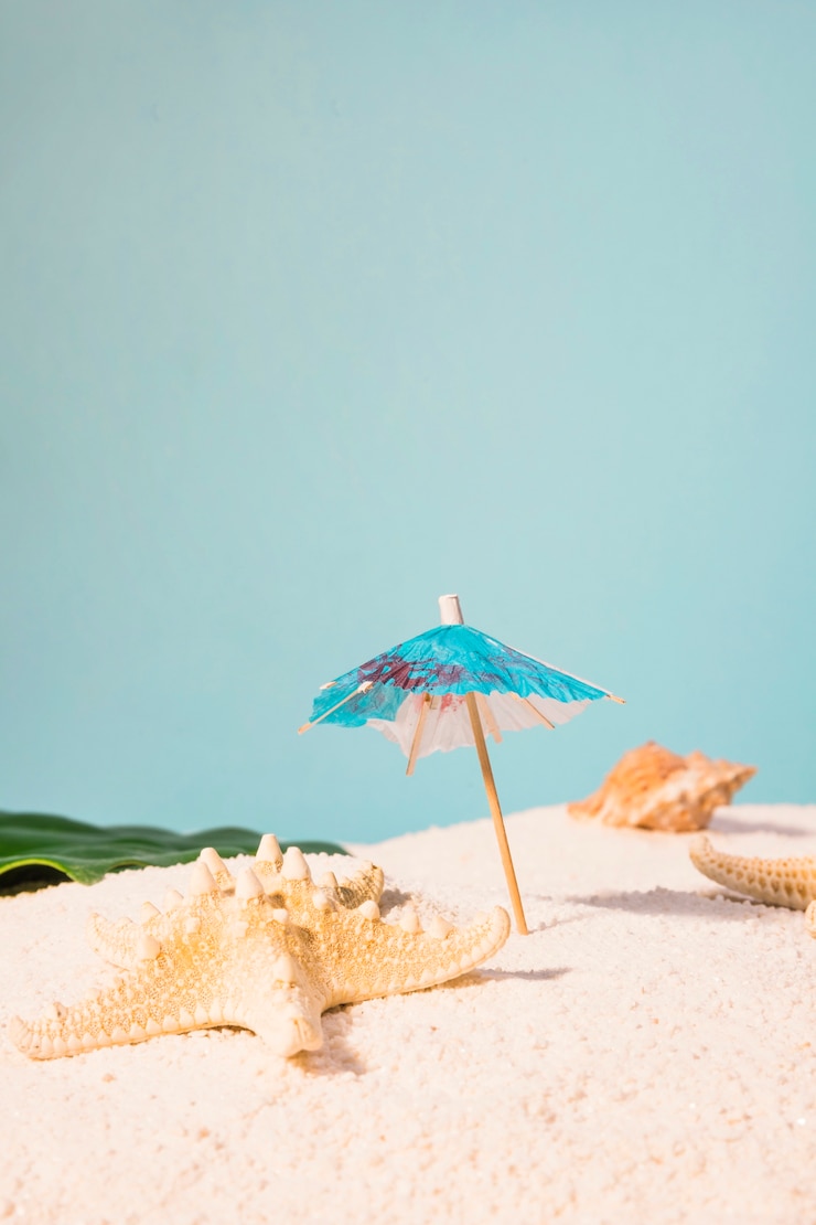Bezpłatny plik Zdjęcie koktajl parasol i rozgwiazda na plaży