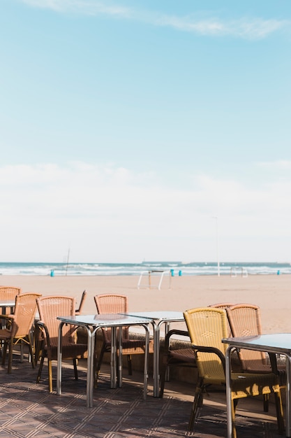 Bezpłatne zdjęcie koncepcja plaży ze stołami i krzesłami