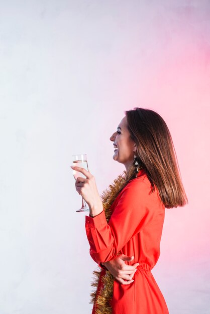 Laughing lady in red dress with champagne flute