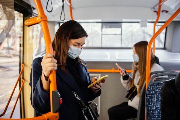 Bezpłatne zdjęcie ludzie noszący maski w transporcie publicznym