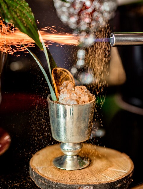 Lustrzana szklanka mrożonego koktajlu przyozdobionego spalonym cynamonem