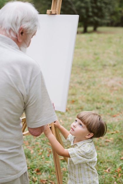 Bezpłatne zdjęcie malowanie dziadka i obserwowanie wnuka