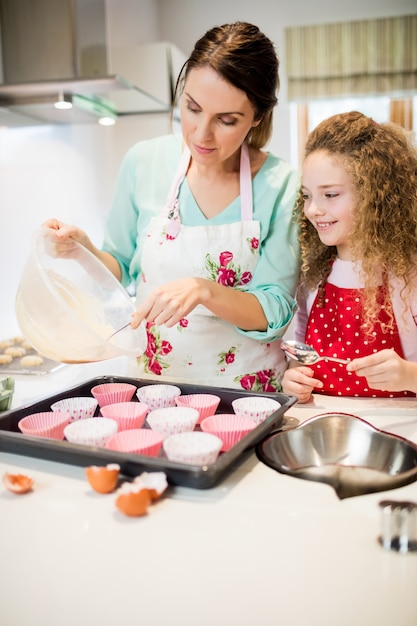 Matka i córka w kuchni przygotowując ciastko