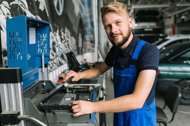 Mechanik używa notatnika przy garażem