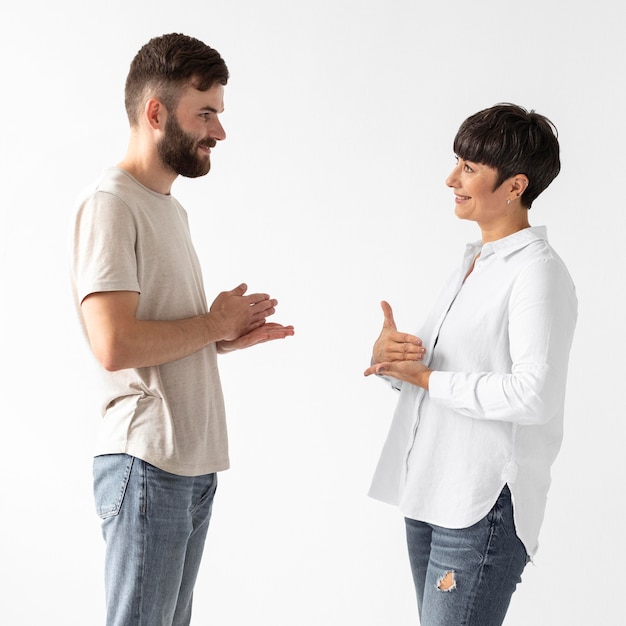 Bezpłatne zdjęcie mężczyzna i kobieta komunikują się za pomocą języka migowego