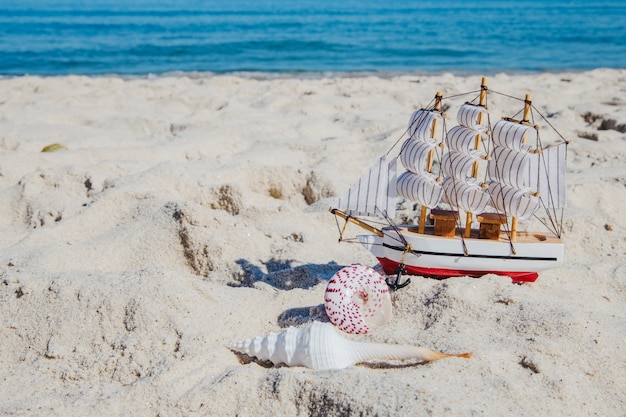 Miniatura statku na tropikalnej plaży