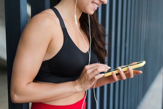 Młoda atlety kobieta z smartphone