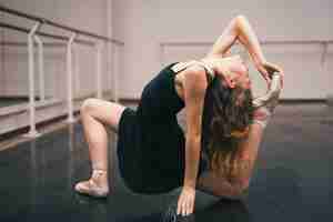 Bezpłatne zdjęcie młoda balerina ćwiczy w tana studiu