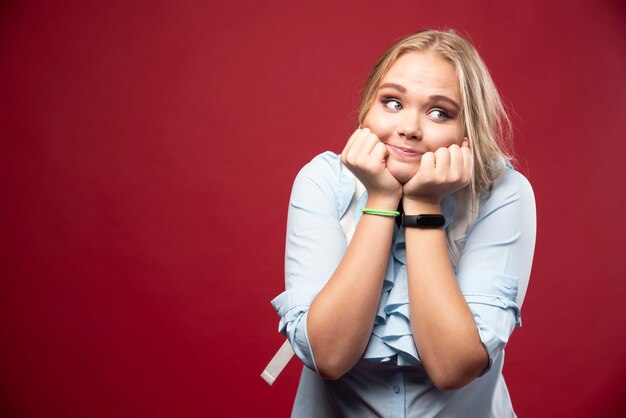 Bezpłatne zdjęcie młoda blond studentka z plecakiem wraca do szkoły i czuje się urocza i szczęśliwa.